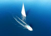 sailing yacht sailboat motor boat at blue sea